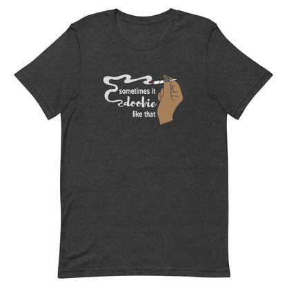A dark heathered grey crewneck t-shirt featuring an illustration of a hand holding a smoking joint. Text alongside the hand reads "Sometimes it doobie like that" with the word "doobie" made of smoke from the joint.