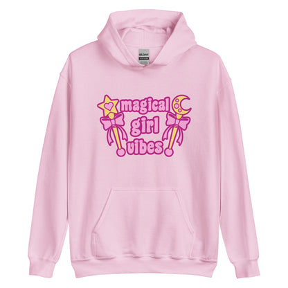 A light pink hooded sweatshirt featuring two gold wands with pink bows and pink text reading "Magical girl vibes"