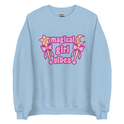 A light blue crewneck sweatshirt featuring two gold wands with pink bows and pink text reading "Magical girl vibes"