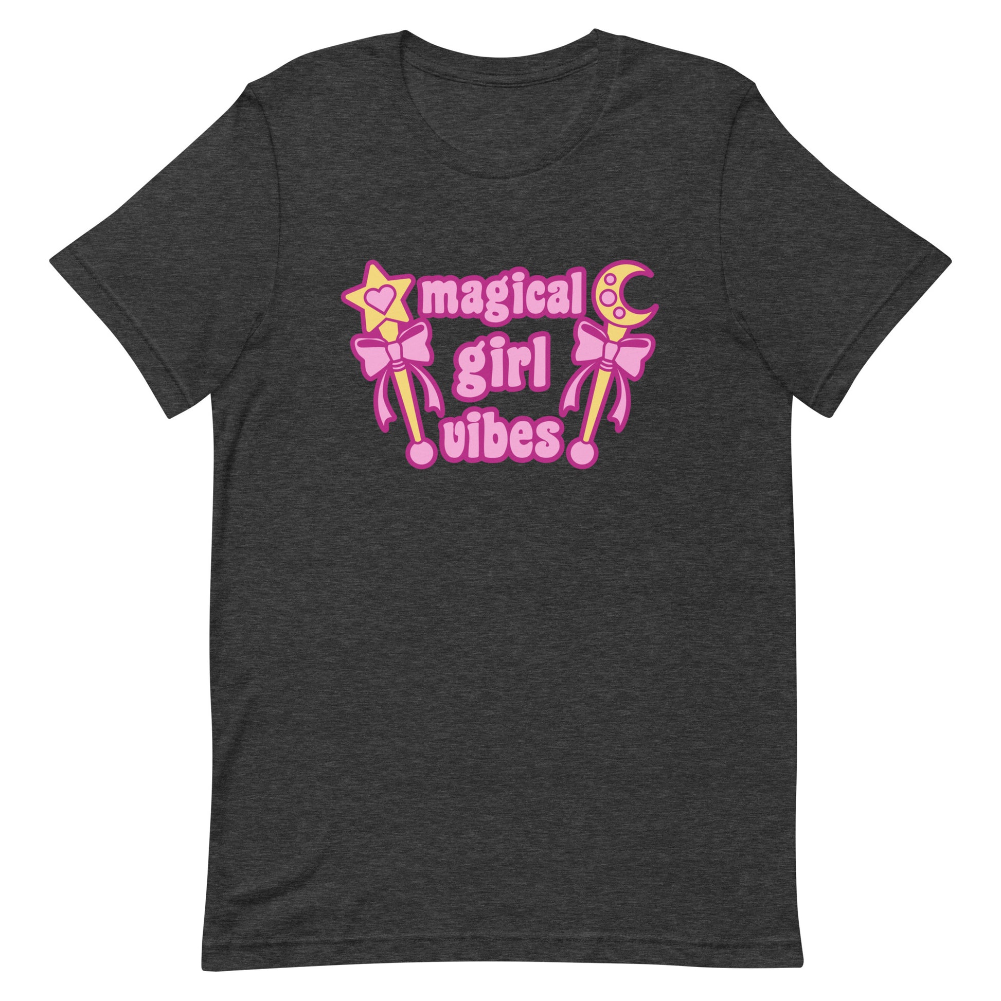 A dark heathered grey crewneck t-shirt featuring two gold wands with pink bows and pink text reading "Magical girl vibes"