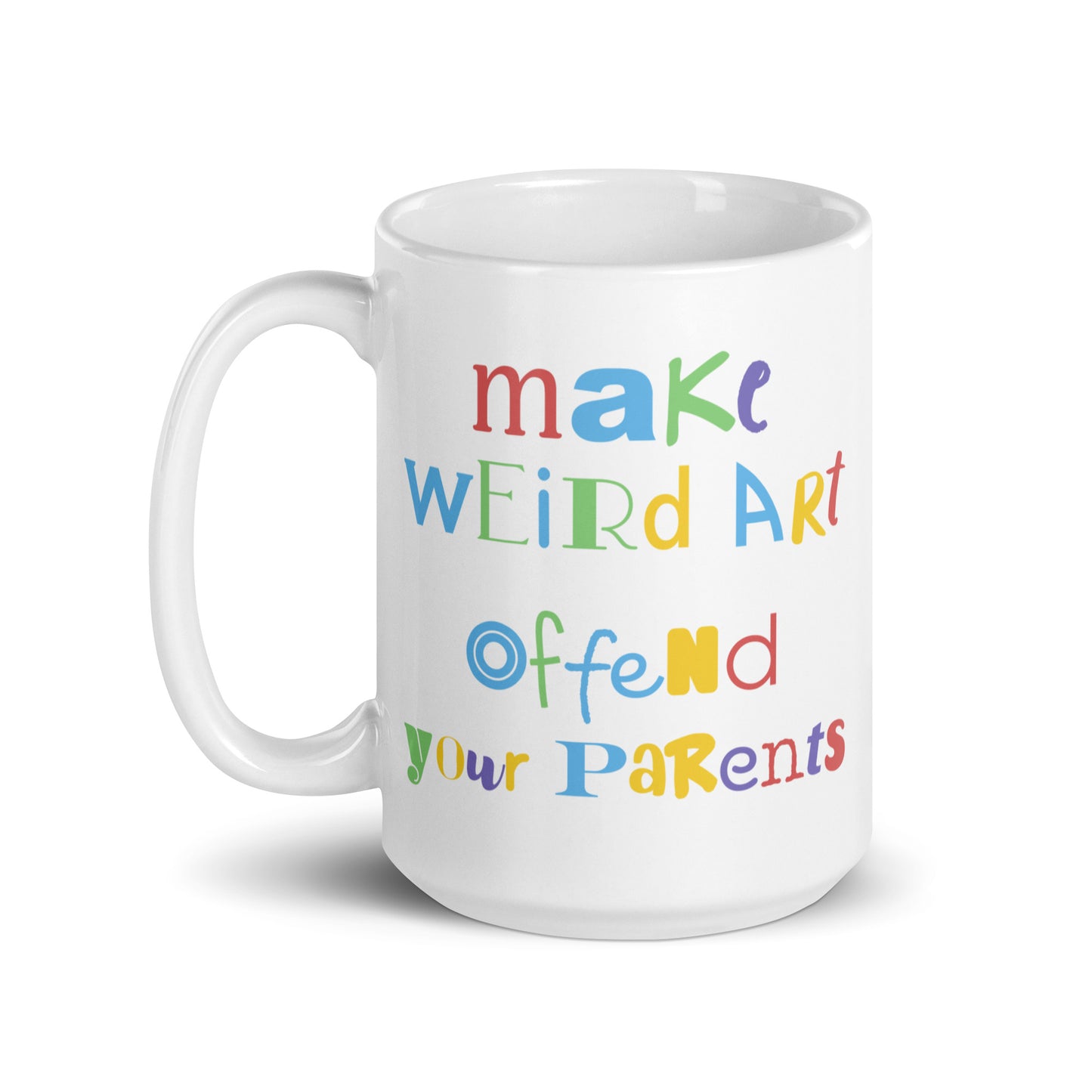 A 15 ounce white ceramic mug featuring text that reads "make weird art, offend your parents" in varying fonts and colors