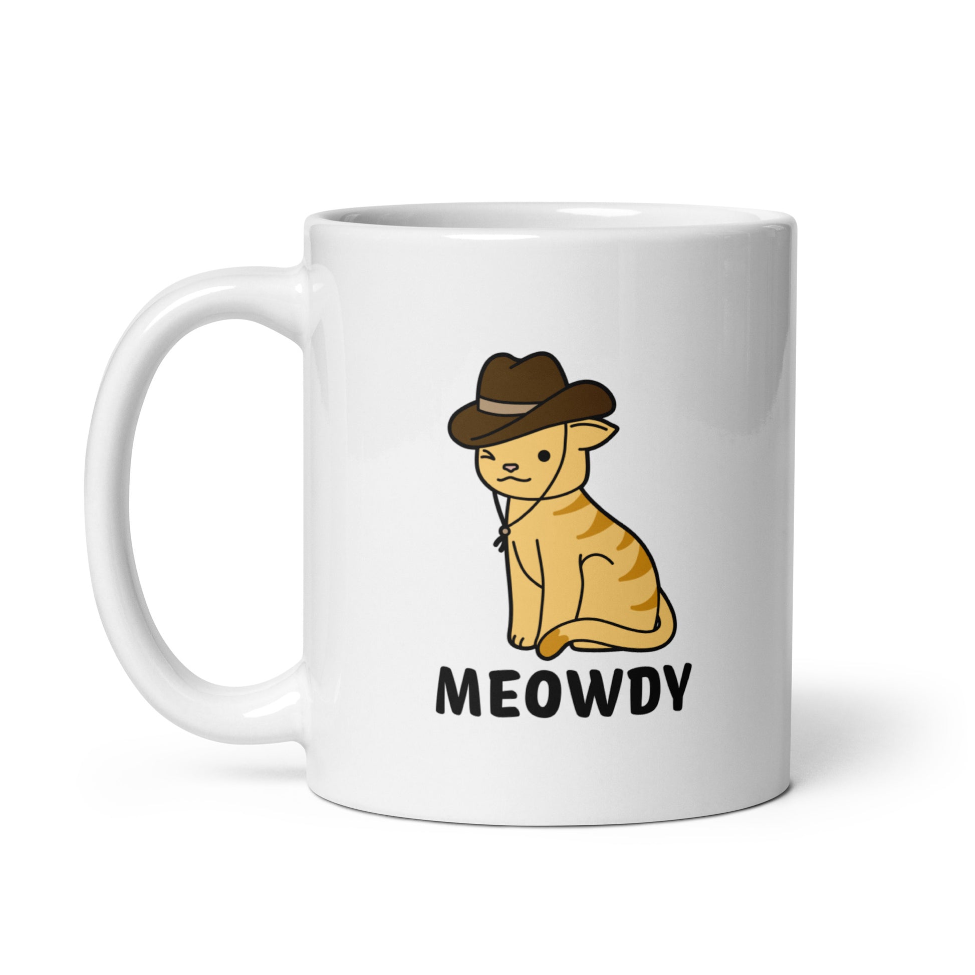 A white, 11 ounce ceramic coffee mug featuring an illustration of an orange striped cat wearing a cowboy hat. The cat is winking and smiling, and text beneath him reads "Meowdy"