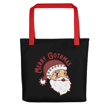 A black tote bag with red handles featuring an image of Santa Claus. Santa is wearing goth-style makeup and his hat is decorated with spikes. Text above Santa's head reads "Merry Gothmas"