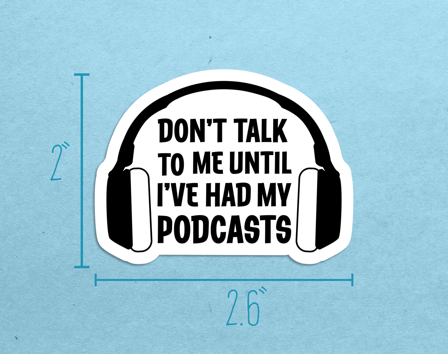 A die-cut sticker featuring headphones and text reading "Don't talk to me until I've had my podcasts" with measurements showing a height of 2" and a width of 2.6"