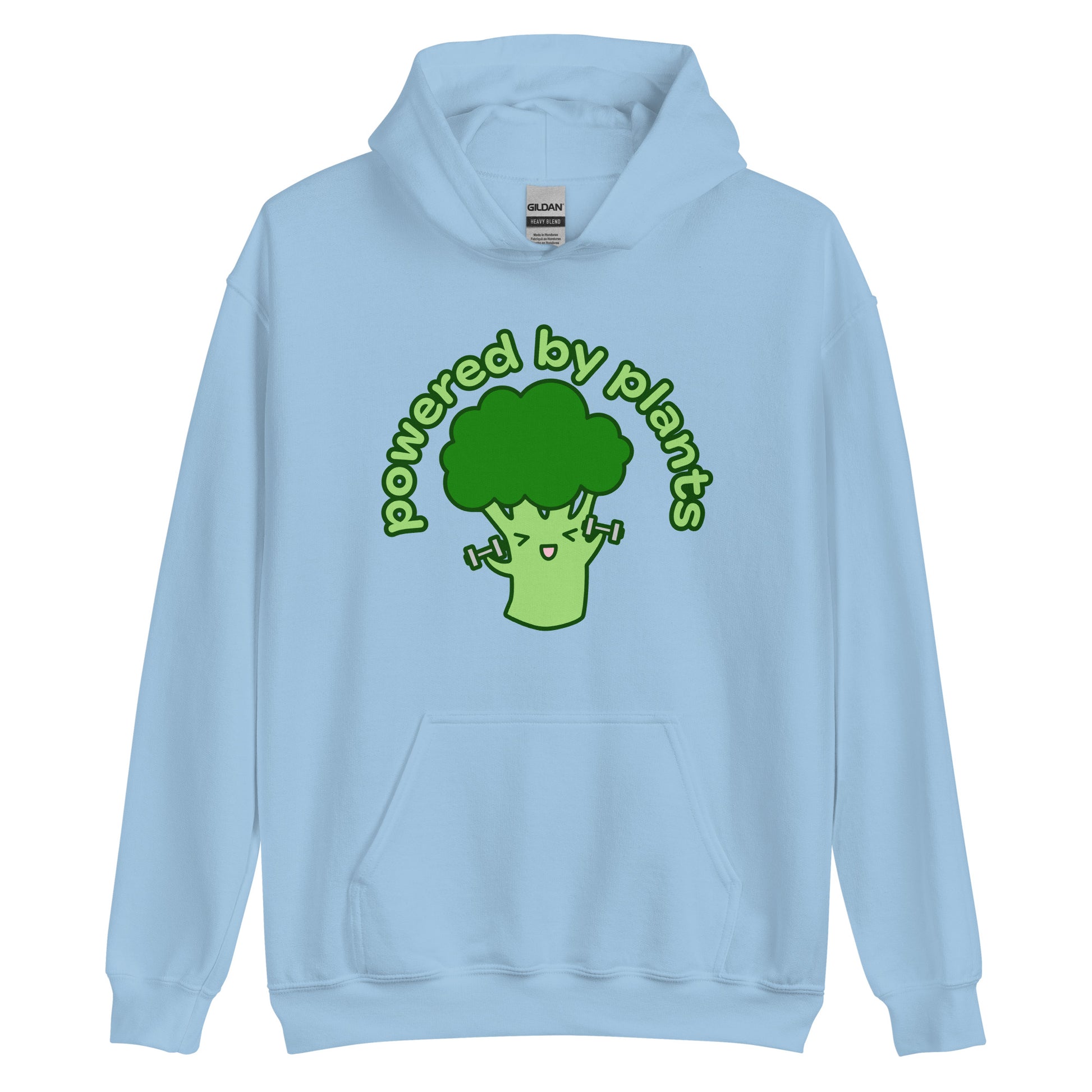 A light blue hooded sweatshirt featuring an illustration of a cartoon broccoli character. The broccoli is excitedly lifting weights, and text in an arc above the broccoli reads "powered by plants".
