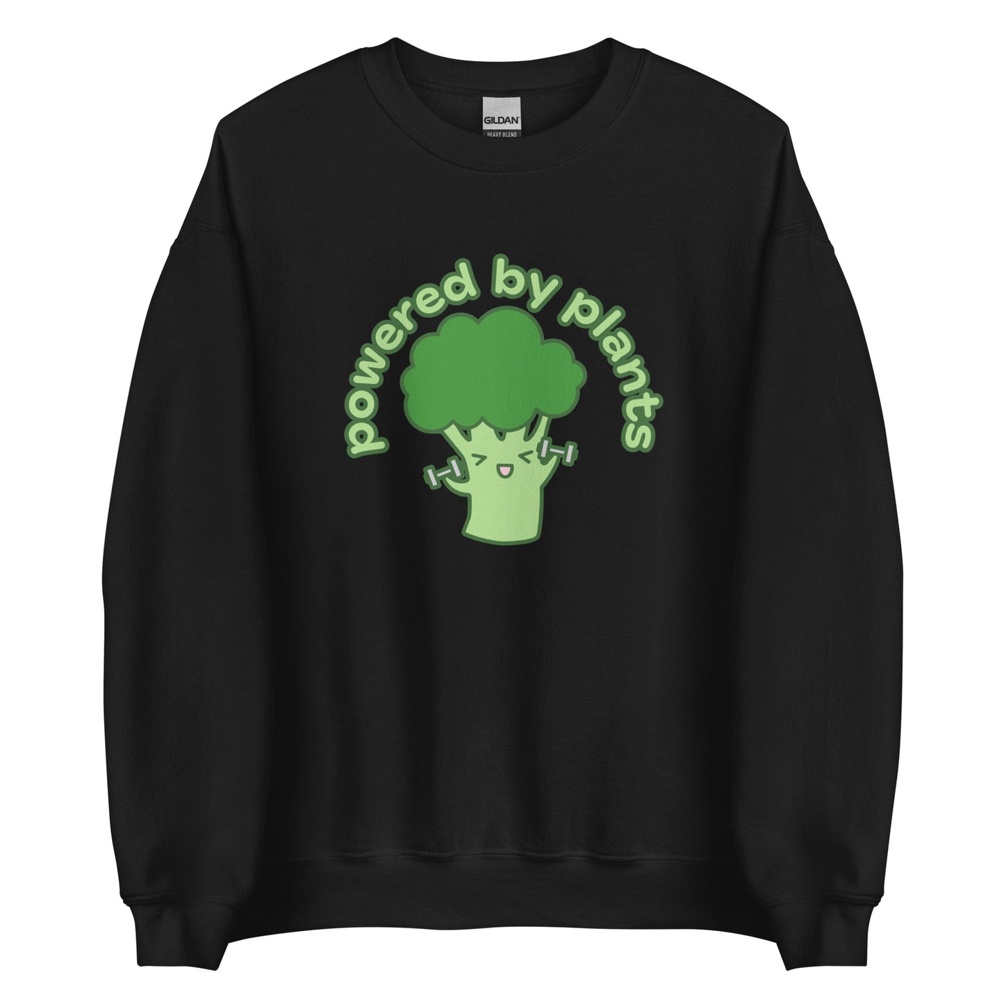 A black crewneck sweatshirt featuring an illustration of a cartoon broccoli character. The broccoli is excitedly lifting weights, and text in an arc above the broccoli reads "powered by plants".