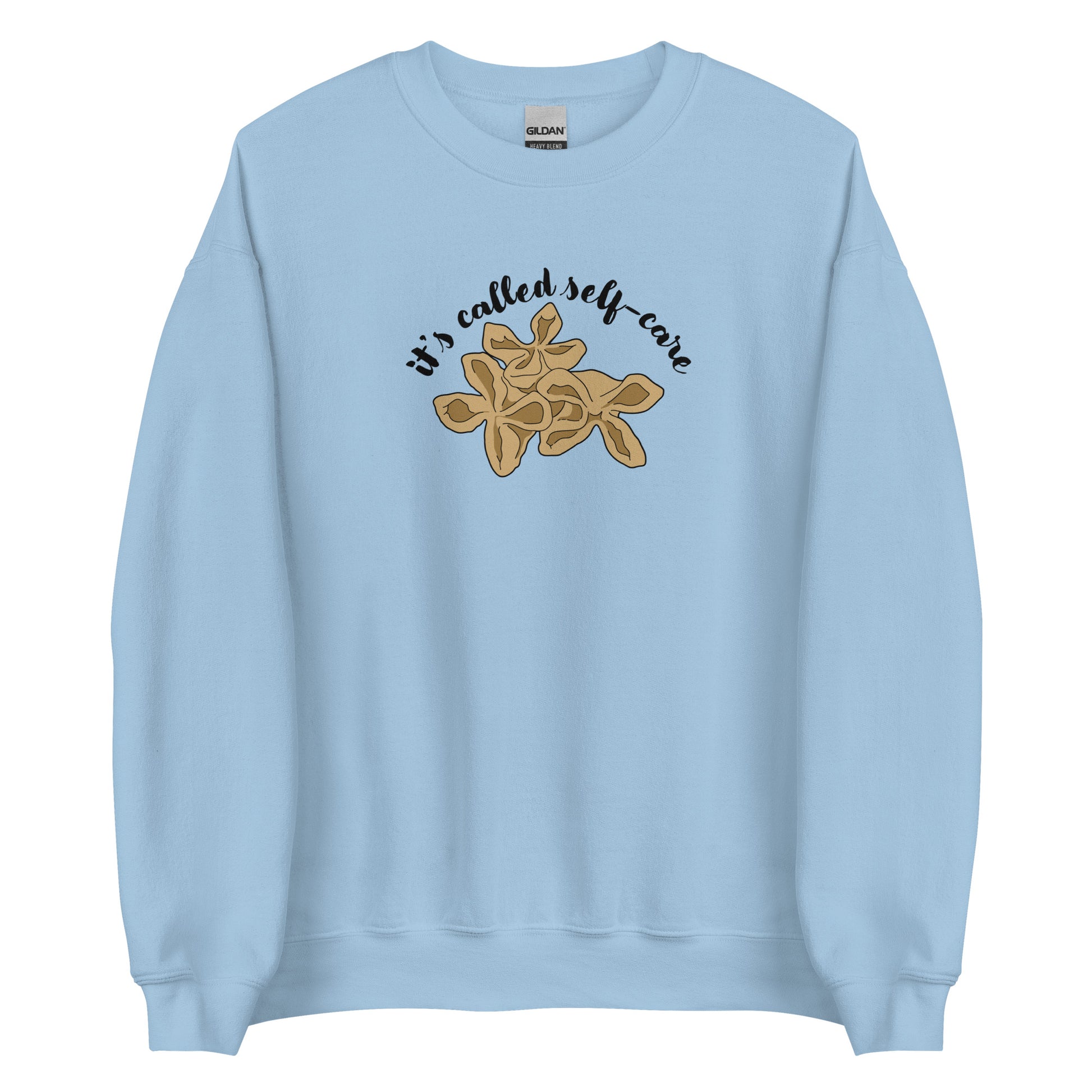 A light blue crewneck sweatshirt featuring an illustration of three pieces of crab rangoon. Text in an arc above the crab rangoon reads "it's called self-care" in a cursive script.
