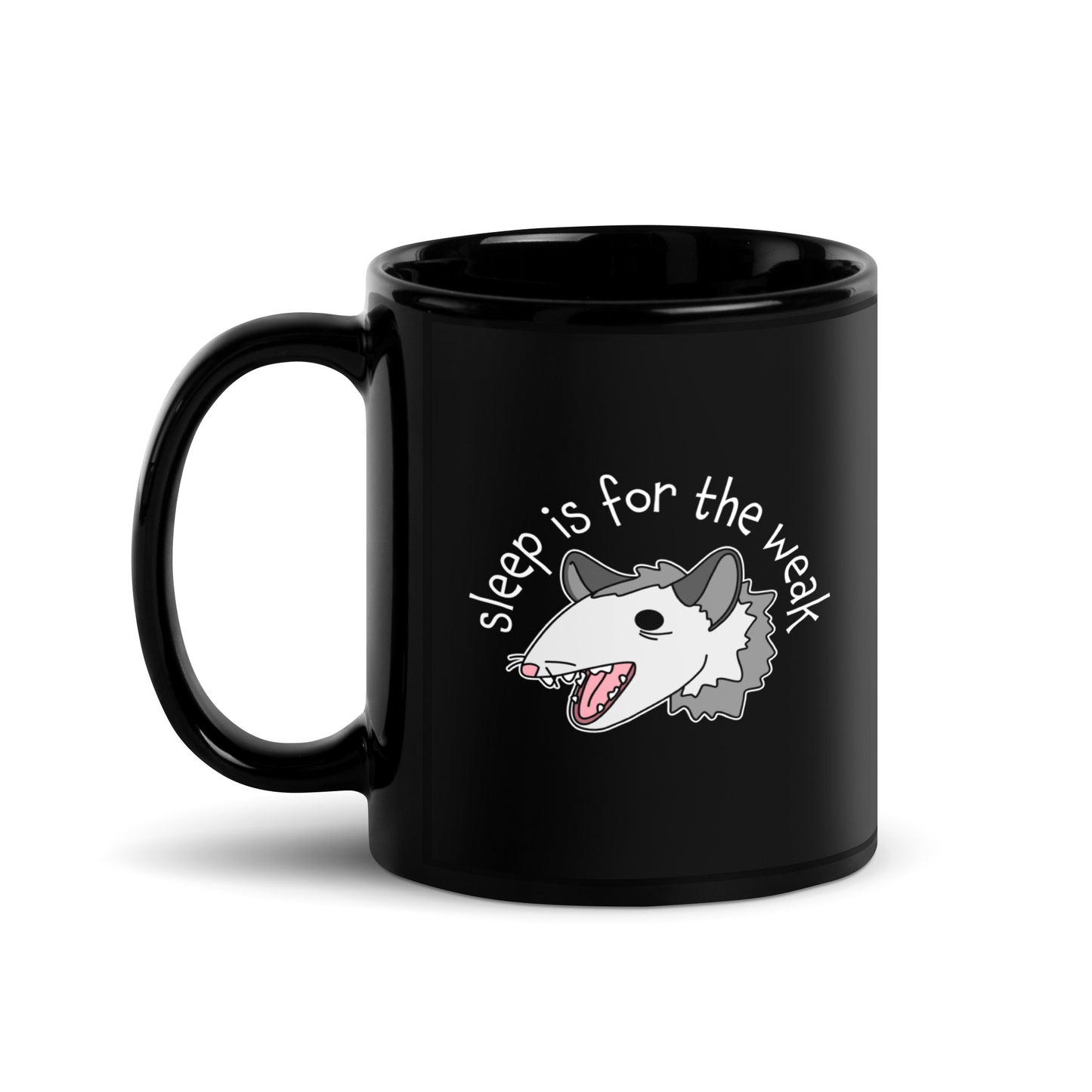 A black 11 ounce ceramic coffee mug featuring an illustration of an opossum with its mouth open, as if it was yelling. Text arching above the opossum reads "sleep is for the weak"