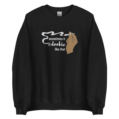 A black crewneck sweatshirt featuring an illustration of a hand holding a smoking joint. Text alongside the hand reads "Sometimes it doobie like that" with the word "doobie" made of smoke from the joint.