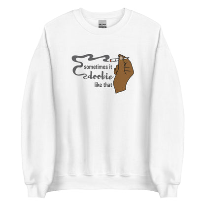 A white crewneck sweatshirt featuring an illustration of a hand holding a smoking joint. Text alongside the hand reads "Sometimes it doobie like that" with the word "doobie" made of smoke from the joint.