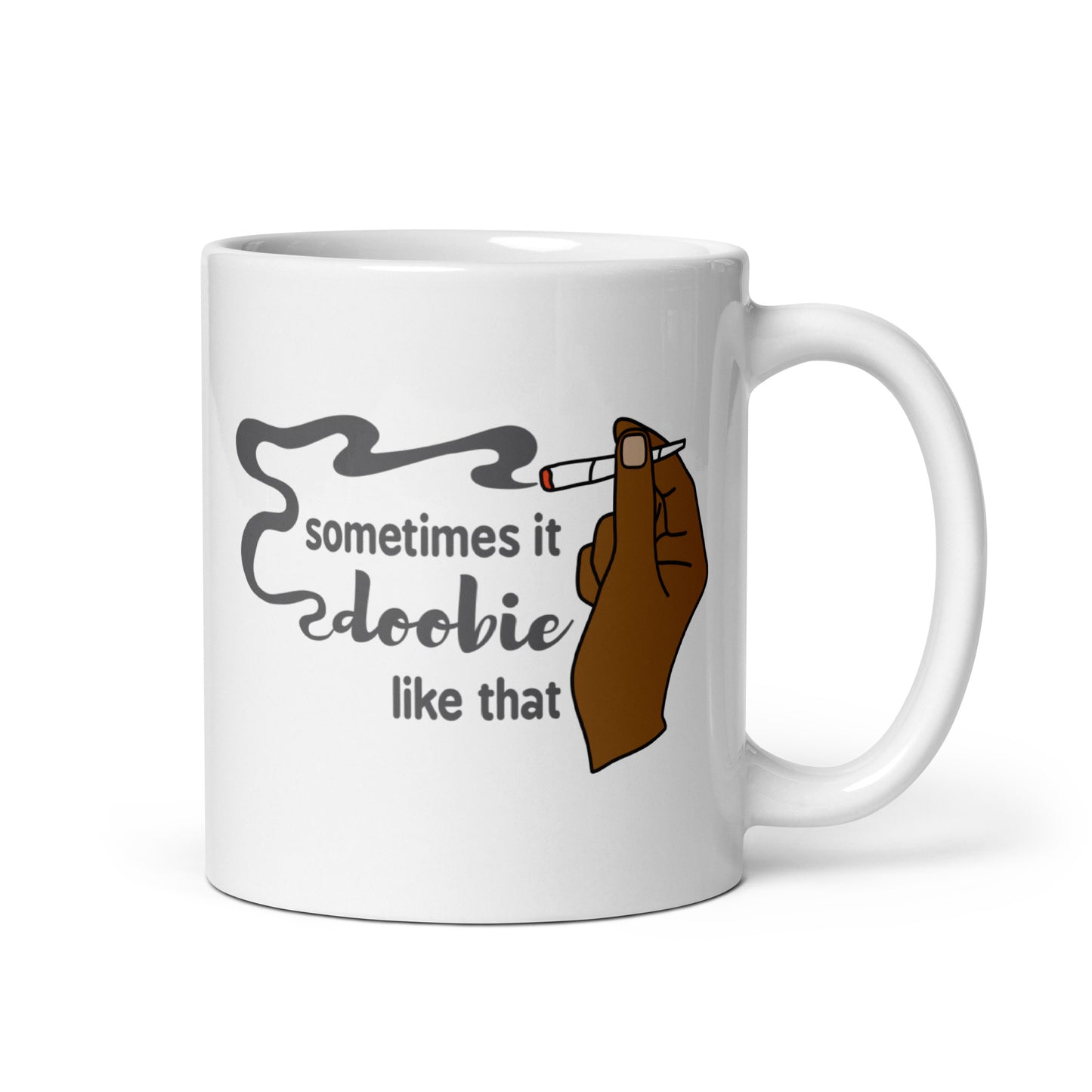 A white 11 ounce ceramic coffee cup featuring an illustration of a hand with deep brown skin holding a joint. Text alongside the hand reads "sometimes it doobie like that" with the word "doobie" made from smoke from the joint.