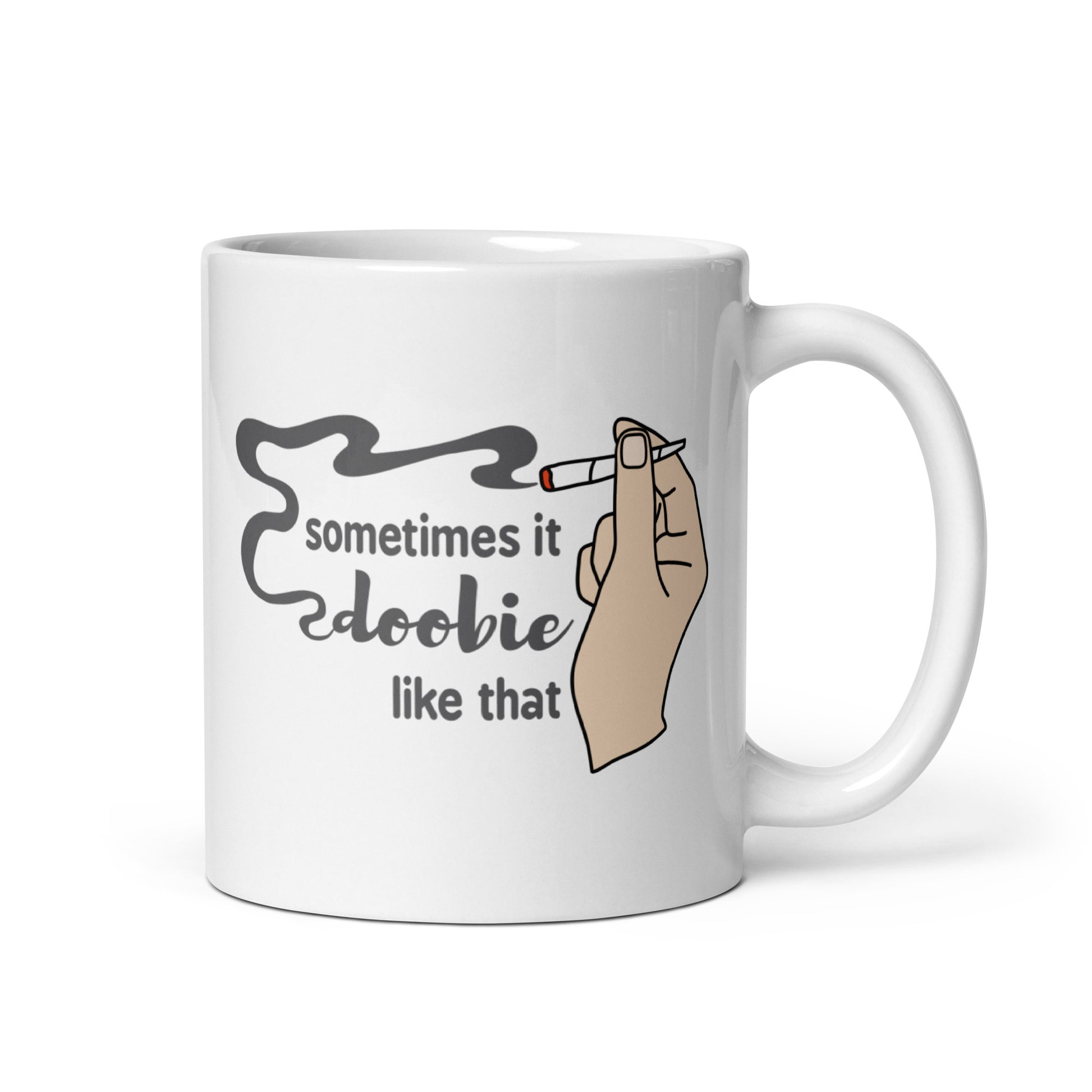 A white 11 ounce ceramic coffee cup featuring an illustration of a hand with light skin holding a joint. Text alongside the hand reads "sometimes it doobie like that" with the word "doobie" made from smoke from the joint.