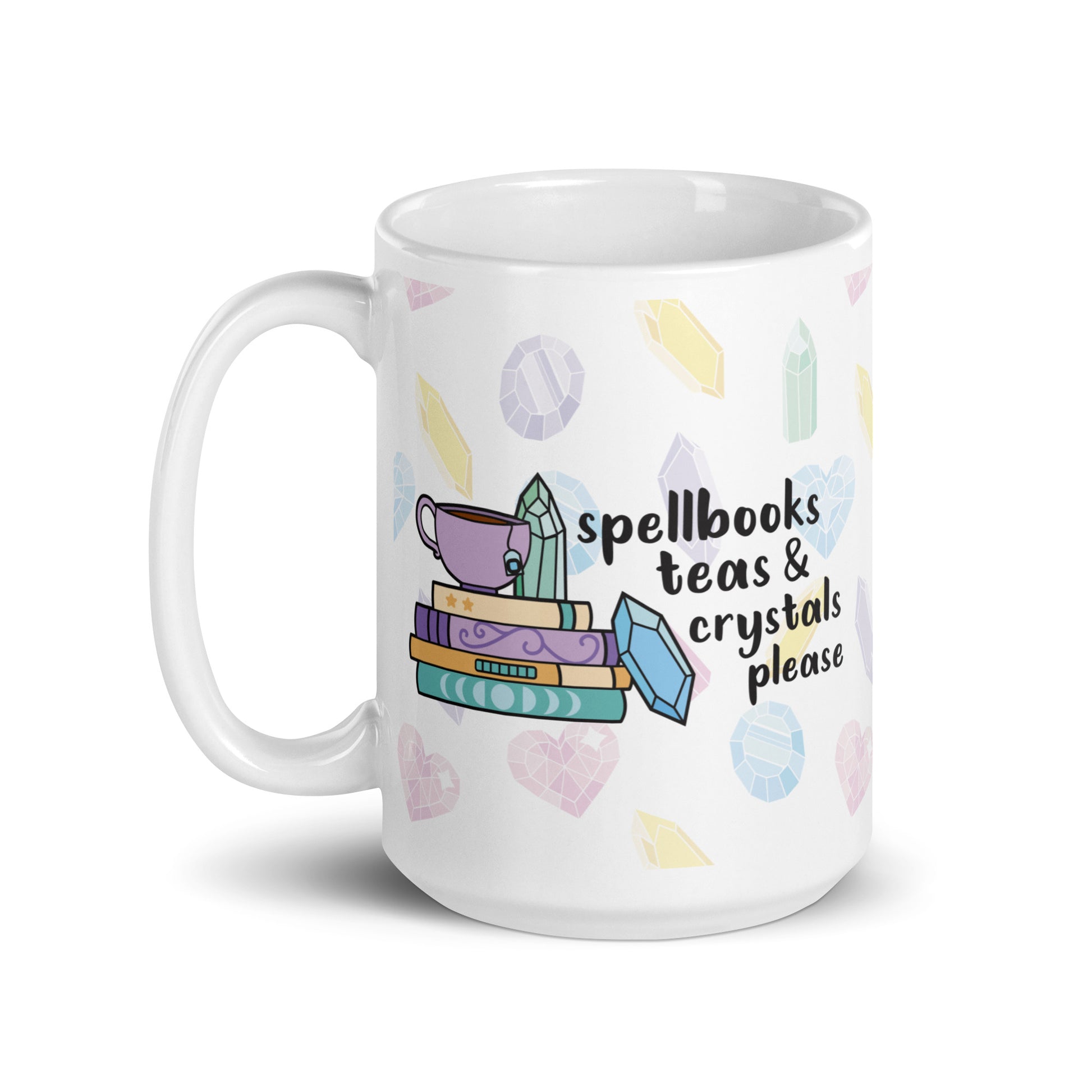 A white 15 ounce ceramic mug with a pattern of pastel crystals. In the center of the mug is an illustration of several books and crystals and a teacup. Text along side the image reads "Spellbooks, teas, & crystals please"