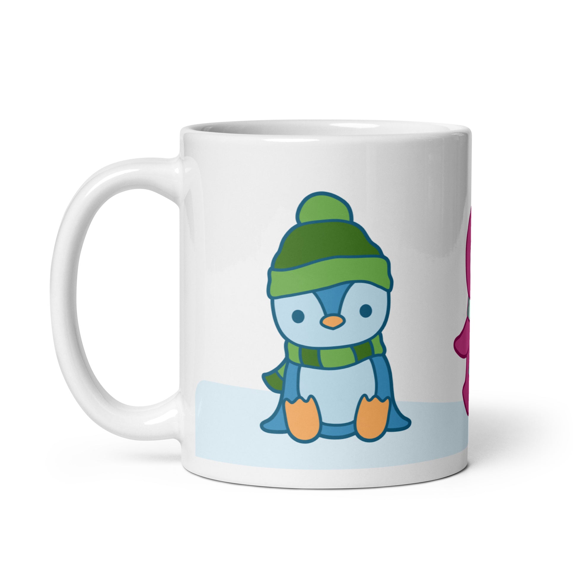 A white 11 ounce ceramic mug featuring an illustration of peguins in the snow. The primary visible penguin is blue, with a green hat.