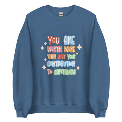 A blue crewneck sweatshirt featuring colorful hand-written-style text that reads "You are worth more than just your contribution to capitalism". Sparkles surround the text on each side.