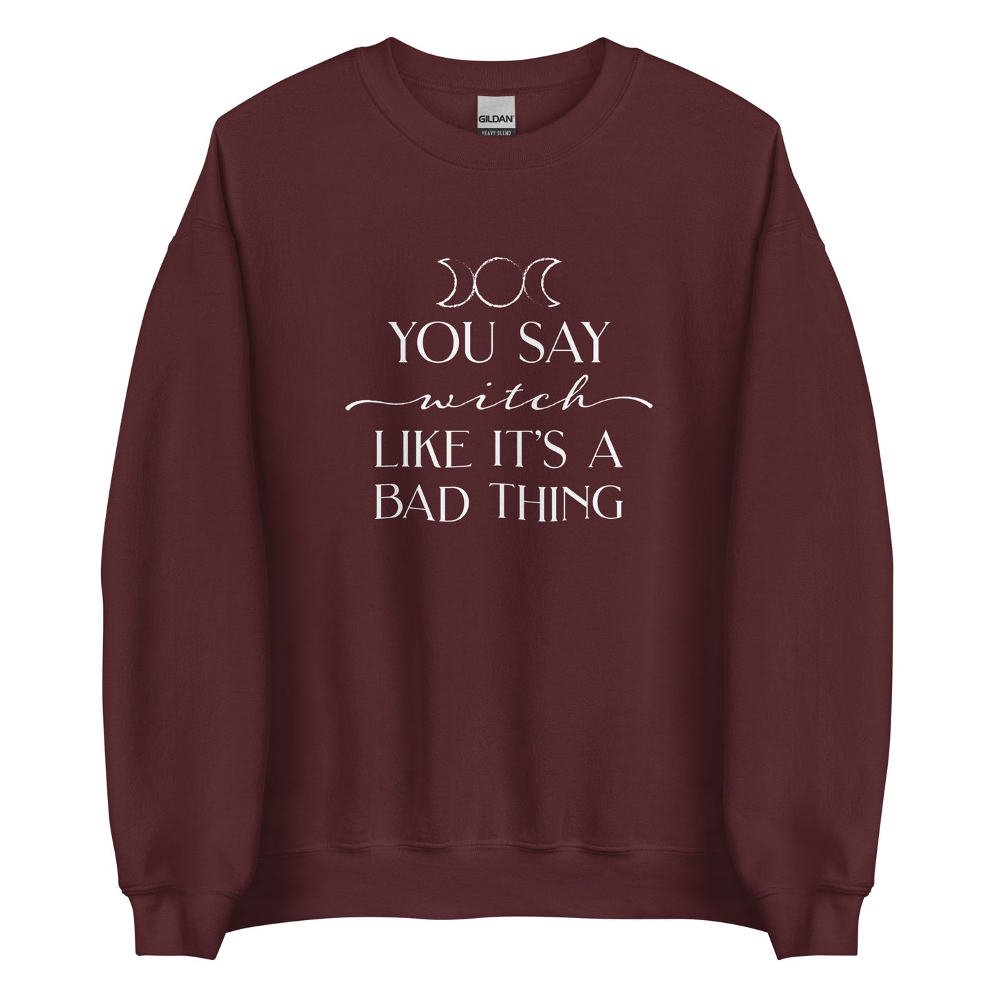 A maroon crewneck sweatshirt featuring the triple goddess symbol and text reading "You say witch like it's a bad thing"