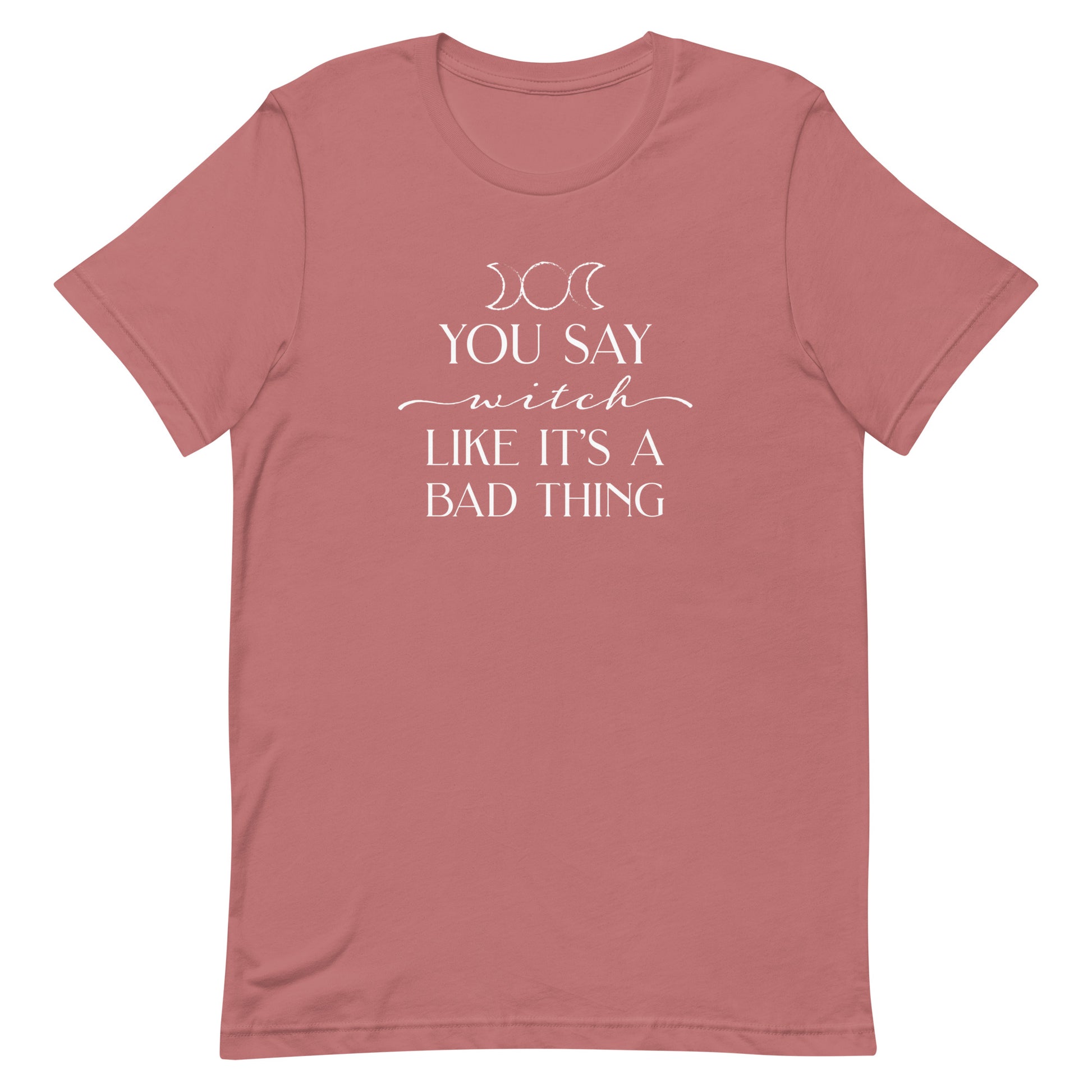A light mauve crewneck t-shirt featuring the triple goddess symbol and text reading "You say witch like it's a bad thing"