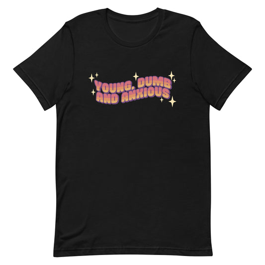 A black crewneck t-shirt featuring text in a pink-to-yellow gradient, surrounded by sparkles. The text reads "Young, dumb and anxious" in a blocky font.